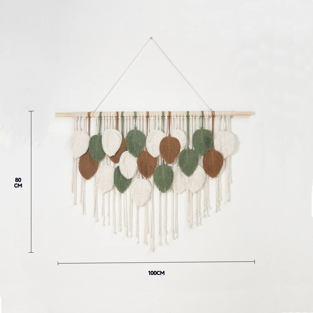 Leaf-patterned tapestry in beige, 100x80 cm, hanging in a cozy room
