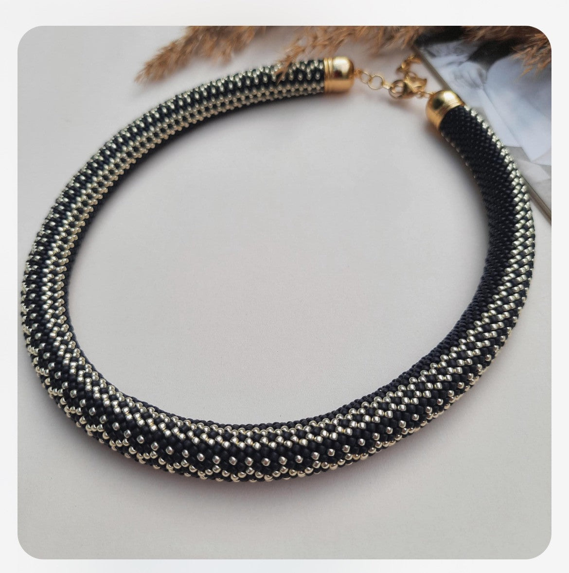 Stylish black and silver bracelet set against a soft fabric background