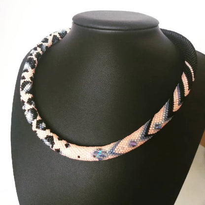 Artisan-designed pink and grey necklace showcasing intricate Japanese beadwork, ideal for gifting.