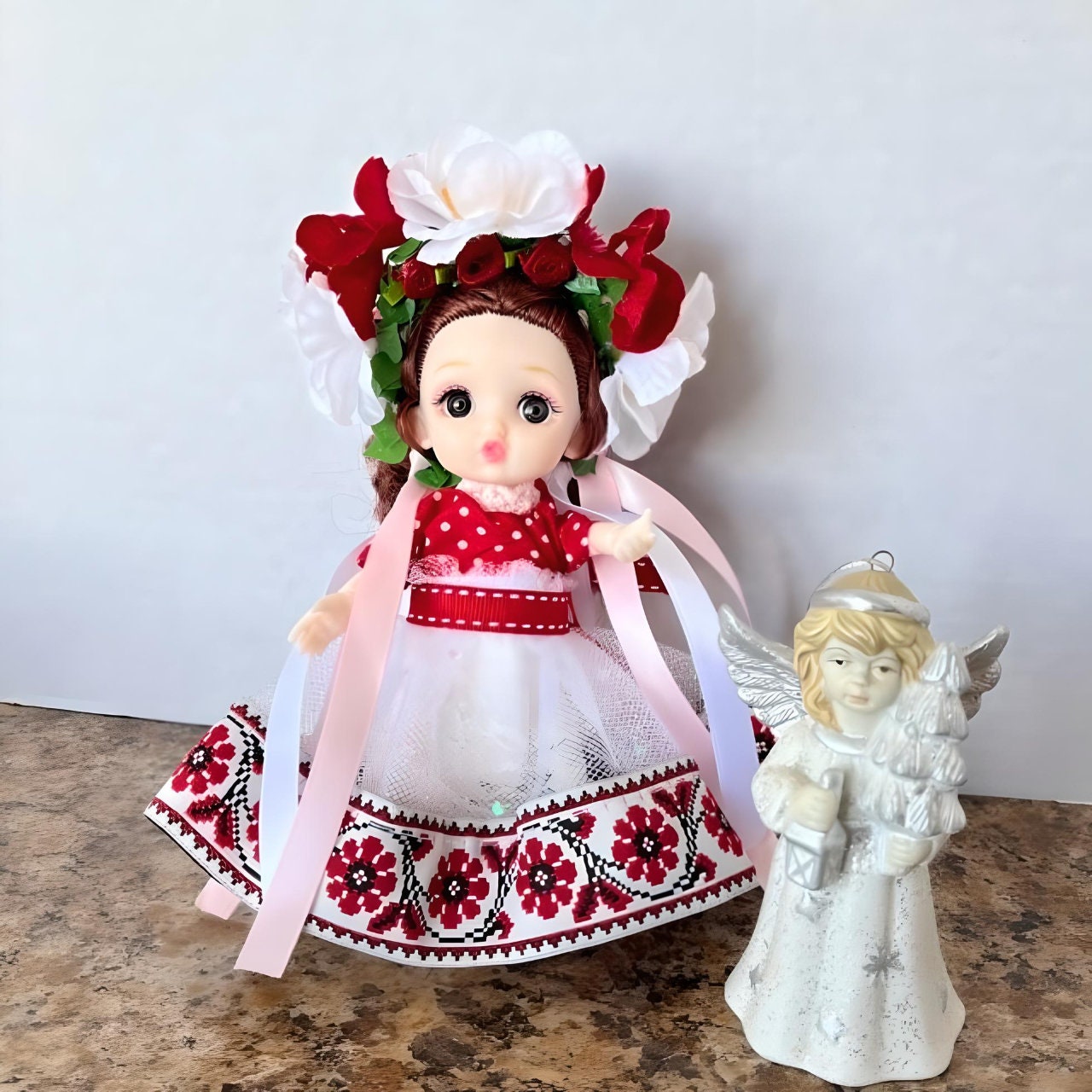 Detailed close-up of Ukrainian doll in red and white dress with floral wreath  | Gift-Emporium